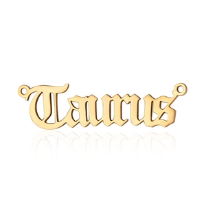 Detailed view of a golden Taurus zodiac letter pendant in polished stainless steel finish