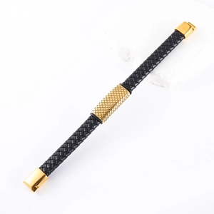 Detailed view of black braided leather bracelet with golden stainless steel clasp