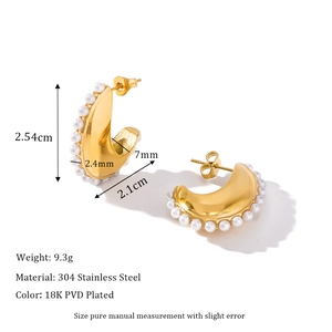 Detailed view of C-shaped 18k gold earrings with dimensions 2.54cm by 2.1cm