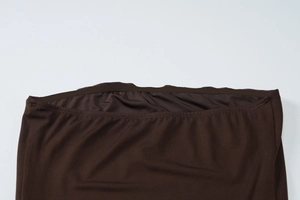 Detailed view of inner non-slip silicone strip on coffee brown strapless dress bodice