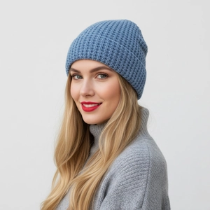 Detail of blue waffle knit beanie hat texture and fit on a model for winter style