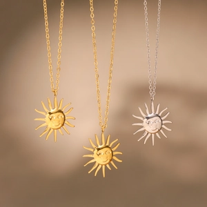 Three celestial sun face pendant necklaces in gold and silver stainless steel finish