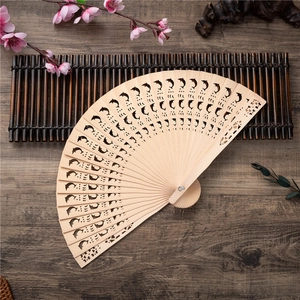 Handcrafted 8-inch wooden folding fan with dolphin hollow carving and natural wood finish