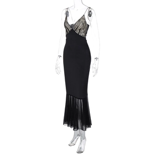 Detailed view of black lace patchwork on a V-neck fishtail dress with sheer mesh hemline