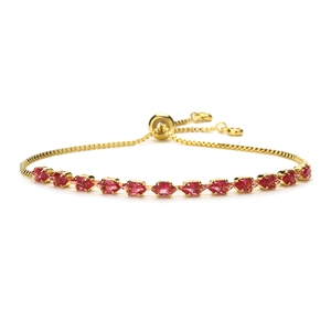 Adjustable golden bolo bracelet with twelve marquise-cut red zirconias in claw setting