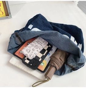 Top view of large capacity denim tote bag showing interior storage for tablets and umbrellas