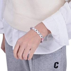 Wrist-worn view of an 8mm pink zebra stone bead bracelet with a Sister charm