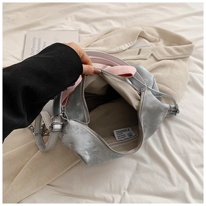 Top-down view of silver butterfly handbag showing large interior space and zipper