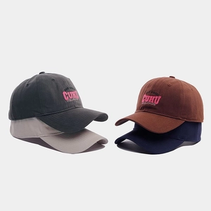 Detail of four colorful cotton baseball caps with pink and white letter embroidery