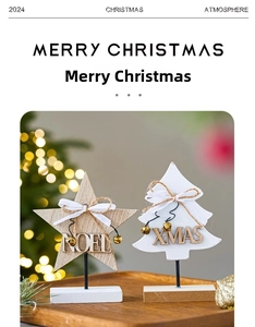 Detail of wooden Noel star and Xmas tree table ornaments with gold bells and white ribbons