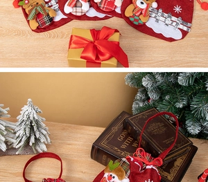 Close-up of velvet Christmas gift bag featuring 3D snowman and festive plaid trim details