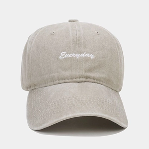 Detailed embroidery of Everyday text on washed cotton baseball cap with vintage texture