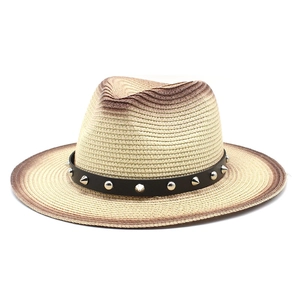 Detail of rivet leather band and gradient weave texture on straw jazz hat