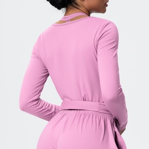 Detail shot of mauve yoga top with cross-back tie design and elastic brushed fabric