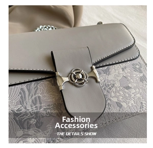 Detailed macro view of the silver metal ring buckle and gray jacquard fabric texture