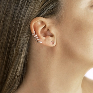 Minimalist silver multi-layer snake ear cuff and round stud set on model's ear