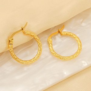 Golden stainless steel spiral textured hoop earrings for women with elegant silk background