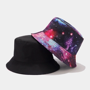 Detail of reversible bucket hats showing both solid black and galaxy print patterns