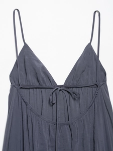 Detail of dark grey A-line dress featuring crinkle texture and V-neck drawstring