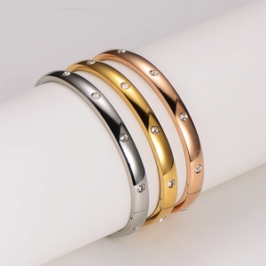 Polished stainless steel bracelets in silver, gold, and rose gold with inlaid crystals