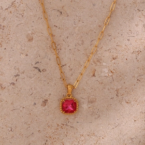 Detailed shot of a red square gemstone pendant on a golden paperclip link chain
