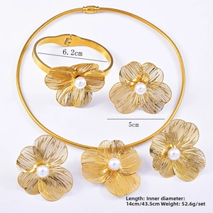 Detailed view of gold filigree flower jewelry with white pearl centers and sizing specs
