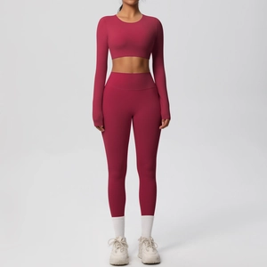 Deep red seamless two-piece yoga set with long sleeve crop top and high waist leggings