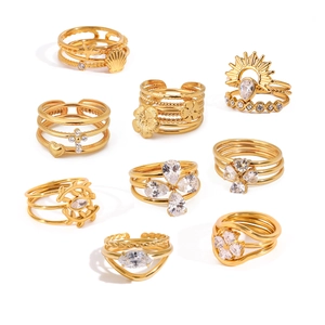 Set of nine minimalist multi-layer gold stainless steel rings with zirconia and floral motifs
