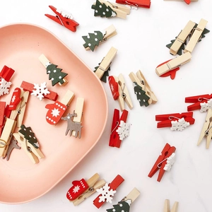 Christmas wooden clips with snowflake reindeer and tree patterns in festive colors