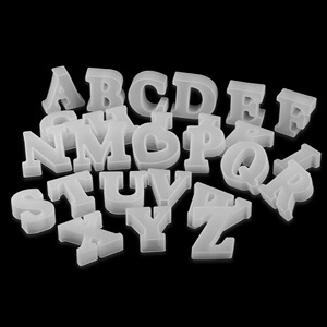 Macro shot of 26 translucent white silicone alphabet molds for crystal resin DIY crafts