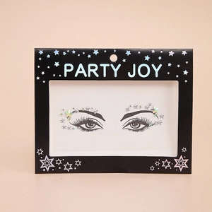 Detail of holographic star and dot face jewels for makeup in branded party packaging
