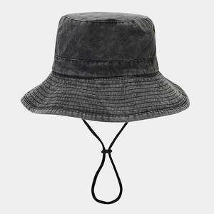 Detail view of washed denim bucket hat with reinforced stitching and adjustable chin strap