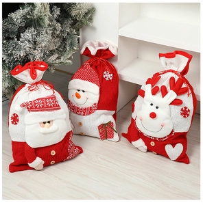 Close-up of three knitted Christmas gift bags with 3D Santa, snowman and reindeer designs