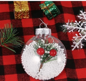Close-up of clear Christmas ornament with berries and pine needles on checkered tablecloth