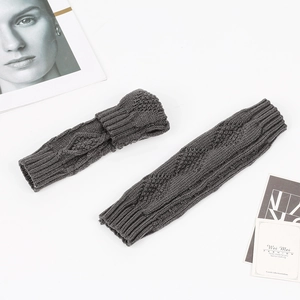 Detailed macro view of dark grey cable knit arm warmers with premium texture
