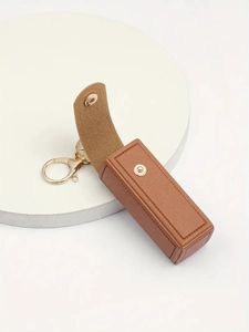 Detail showing brown PU leather lipstick holder case with gold metal snap and clasp