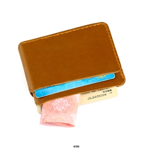 Detailed close-up of brown crazy horse leather card holder with hand-stitched stitching