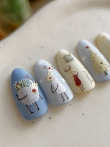 Macro shot of long almond Christmas nail art with deer and tree patterns in light blue