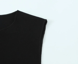 Close-up of neckline and shoulder stitching on black sleeveless knit stretch top