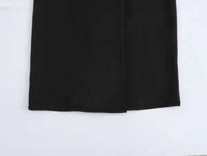 Detailed macro view of the smooth black woven fabric hem and high-quality stitching detail