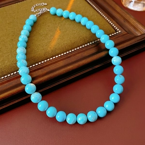 Minimalist turquoise beaded necklace with natural brown textures and metal lobster clasp