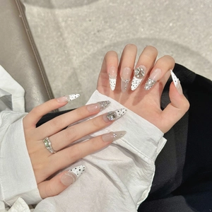 Handmade stiletto press-on nails with cow print, rhinestones and silver chain details