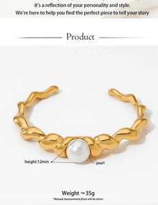 Detail of gold wavy stainless steel bangle with a 12mm pearl and engraved weight info