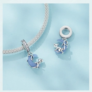 Detailed macro view of S925 sterling silver moon cat charm with blue glowing stone