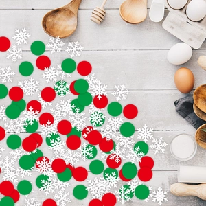 Christmas snowflake and round confetti scattered on a festive holiday wooden table