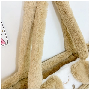 Close-up of plush khaki shoulder bag showing soft faux fur texture and embroidery details