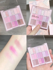 Macro detail of DIKALU 15-color eyeshadow palette with swatches on arm for pink and purple shades