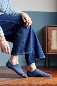 Detailed close-up of dark blue men's five-finger low cut socks with breathable knit texture