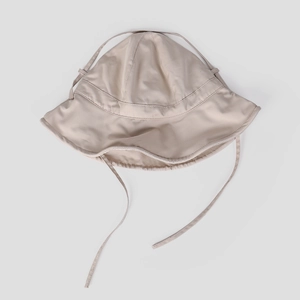 Detail of wide brim sun hat with adjustable windproof chin strap in beige