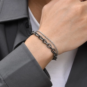 Detail of vintage silver double-layer chain bracelet featuring rope and curb link textures